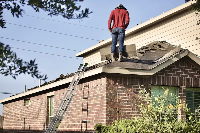 Professional roofer working on a residential roof in Great Meadows